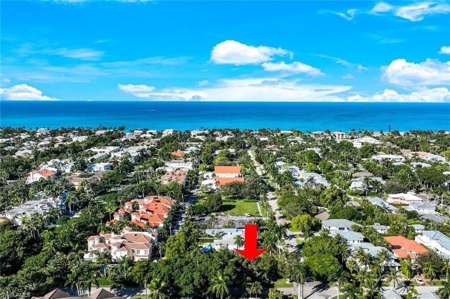 A rare opportunity in the heart of Old Naples. 
This premium .23-acre corner homesite sits at the sw corner of 1st Avenue South and 5th Street South, just 5 blocks from the beach and a short stroll to the world-class dining and boutique shopping of famed Fifth Avenue South. Located in sought after X500 flood plain, 490 1st Ave S offers long-term peace of mind, superior elevation, and build flexibility. No flood insurance required.
Surrounded by mature banyan trees and lush palms, the property provides an inviting tropical landscape with excellent design potential. A private alley allows for rear-entry garage access, enhancing curb appeal while maximizing space for an impressive front façade and expansive outdoor living. 
Preliminary concept sketches by MHK Architecture illustrate a stunning 4,000+ sq ft custom home featuring 4 bedrooms, 4.5 baths, a private guest suite with elevator access, loft, additional laundry, spectacular pool, and oversized 2-car garage with alley access. 
Whether you envision timeless coastal architecture, West Indies charm, or a clean modern aesthetic, the design possibilities here are exceptional.
Create your own piece of paradise in one of the most coveted walkable beach neighborhoods in Old Naples.