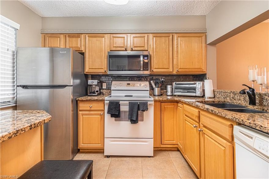 A Clean and Meticulously maintained unit. Come see for yourself! FULLY FURNISHED/TURNKEY for your convenience. Gorgeous views of the Golf Course and lake too.  Stackable Washer and Dryer and Porcelain Tile Flooring throughout the unit.  Kitchen has been updated with New cabinets, tile backsplash and Granite Countertops, and a lazy susan which offers you  more storage.  Refrigerator, microwave and disposal are only a couple years old.   Bathrooms have been updated with 36 Inch Vanities, new lights and mirrors.  Bicycles in the unit are also included in the purchase.  Along with Golf Cart Space T4 and golf cart which has a new charger.  A storage closet off the lanai and an additional closet by the elevators where you can store a few more of your belonging.   You'll love the upgrades and amenities this property has to offer.  All windows in this condo are hurricane impact resistant so well as the sliding door off the main living area.  Hurricane accordion Shutters for the Lanai.  Cross Breezes are Fantastic. This well-maintained community also boasts 6 heated pools, an Executive 18 hole golf course, auditorium for dinners and dances, full activities department which has a newsletter with monthly activities, tennis, pickle ball, shuffleboard, bocce ball, to name a few of the amenities offer at Seven Lakes. All amenities and your cable/internet, water/sewer, trash removal and lawn maintenance are covered in your monthly condo fee.  Your monthly electric service is your responsibility.  Seven Lakes has a convenient location close to shops, restaurants, both Fort Myers and Sanibel beaches and minutes away from the international airport.   Don't wait another minute to start living the Florida dream - come see this incredible property today!
