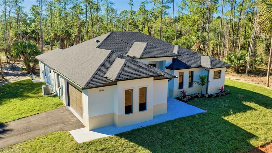 Welcome to an exquisite newly built 3 bedroom 3 bathroom plus den home located on 2.73 totally upland acres in the heart of Naples. Upon entry, the home offers a welcoming and open feel with warm wood-toned flooring throughout, creating a balance of comfort and modern design. The kitchen boasts an elegant two tone combination of natural wood and white acrylic handless cabinets, seamless Taj Mahal countertops, and stainless steel Samsung appliances. A whole house reverse osmosis water system, a fabulous primary suite, fully custom closet systems designed to maximize storage and functionality, and custom Italian doors add to the property’s allure and value. The home also offers an oversized covered patio ideal for sitting outside for a morning coffee or hosting family gatherings. An oversized two-car garage with Epoxy flooring. Situated conveniently near Big Island Corkscrew Park; perfect for family days at the park and a wonderful plaza anchored by Publix. Welcome Home!