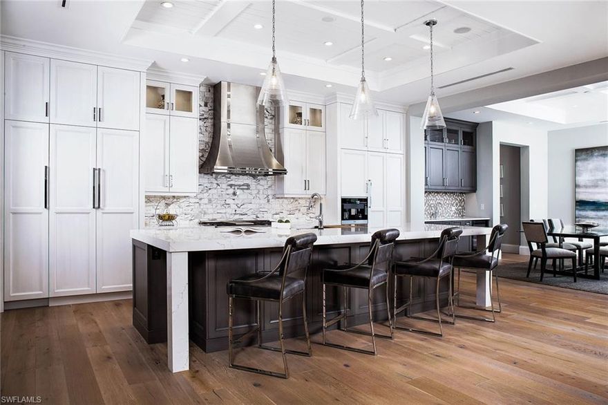 This sprawling 5,012-square-foot home is located in the heart of Olde Naples with close proximity to beautiful Gulf beaches and Fifth Avenue South. Embrace the Florida lifestyle from this home’s expansive outdoor living area with pool and spa, summer kitchen, and covered and uncovered seating areas all accented by the glow of fire bowls. This new construction home features wide-plank hardwood flooring, tankless hot water systems, a camera security system, five bedrooms, five plus two-half baths, a den and guest casita. The custom glass wine room is designed with a stylish, contemporary wine rack featuring a sensory driven climate controlled chilling system. The chef will enjoy the Miele® appliances, quartz countertops and custom-built cabinets. Entertain with ease with a large open concept floor plan transitions seamlessly to stunning outdoor spaces. This home showcases the best of Florida living indoors and out.