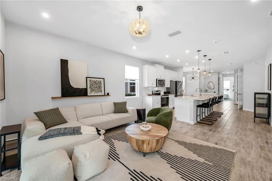 Built in 2023, this end unit features a clean, modern minimalist design and one of the most desirable floor plans in Arboretum, offering 2 bedrooms plus a den, a two-car garage, no one above, and added privacy throughout. The larger private backyard does not back up to other units, creating a rare sense of openness and quiet while still being just steps from the resort-style amenities. The thoughtfully designed layout includes modern lighting, a spacious kitchen with large island, and private patio. This is as close as you can get to single-family living without the upkeep, offering true lock-and-leave convenience with dues covering nearly everything except electric. Residents enjoy a resort-style pool, oversized spa, fire pit, fitness center, grilling area, dog park, and scenic lakefront sidewalks, all just minutes to Naples Bay, the Botanical Garden, Sugden Park, the Bayshore Arts District, Downtown Naples, and Gulf beaches.