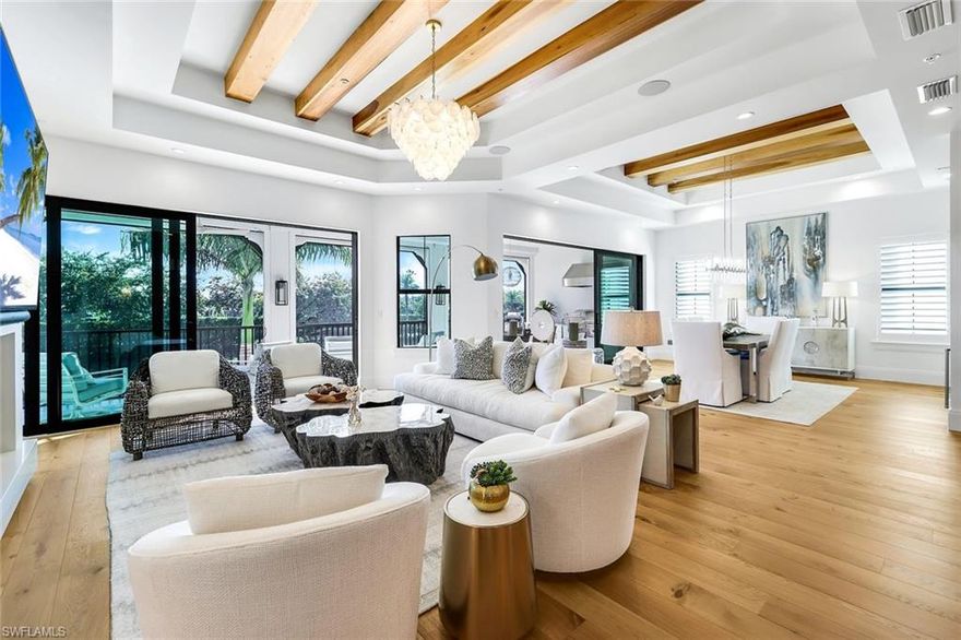 Welcome to an exceptional second-floor residence in the highly desirable Corsica neighborhood of Talis Park, perfectly positioned to capture serene lake view. This beautifully designed 3-bedroom, 3.5-bath condo is filled with natural light and offers an elegant yet comfortable lifestyle in one of Naples’ most sought-after communities.

The open living and kitchen areas are warm and inviting, highlighted by striking wood beam accents and enhanced by Lutron lighting for effortless ambiance and control throughout the home. A stylish fireplace anchors the living room, creating a welcoming space ideal for everyday living and entertaining. The kitchen is truly the heart of the home, featuring a large center island, gas cooktop, high-end appliances, extensive cabinetry, and a layout designed for effortless hosting.

Enjoy the privacy and convenience of a private elevator with direct access to the residence, along with modern comforts including a Lutron shade system and Sonos whole-home music, creating a seamless blend of luxury and technology. The primary suite is a true retreat, complete with an absolutely stunning walk-in closet featuring a built-in vanity, and a luxurious, spa-inspired bath. Guest bedrooms are generously sized and thoughtfully designed to comfortably accommodate family and friends. A flexible loft area, currently used as a den with desk space, offers the perfect setting for a home office or additional lounge area.

The oversized screened lanai showcases peaceful lake views and is ideal for embracing the Naples lifestyle. With a built-in outdoor kitchen and gas grill, this space is perfect for alfresco dining, entertaining, or simply relaxing while enjoying the tranquil surroundings.

Located within the prestigious gates of Talis Park, Corsica offers close proximity to the community’s renowned golf course, dining, and amenities, while remaining just minutes from Naples’ beaches, shopping, and fine dining. This residence stands out as one of the most beautiful condos in Corsica, combining refined design, advanced home features, exceptional light, and a premier location.