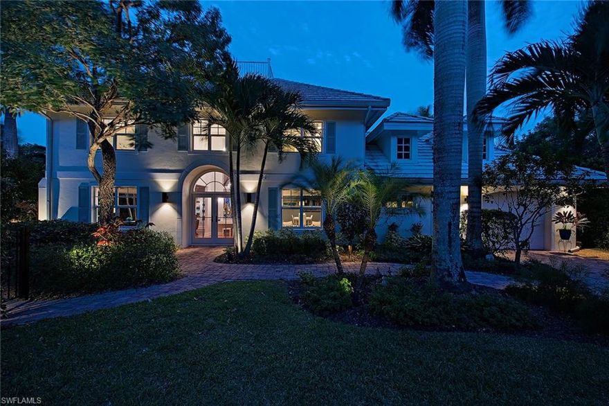 An Old Naples two-story that blends modern and contemporary décor featuring over 3,200 square feet in an ideal location! Just six blocks from the sugar sand beaches and the world-class dining and shopping found on 5th Avenue South. Re-built in 2006, the home was modernized with impact-resistant windows and doors, a new roof, updated plumbing, a new electric panel and new HVAC. The expansive great room features 14-foot pocket sliding doors which open wide to showcase the 800-square-foot, brick-paver terrace and peaceful water garden.  Lush landscaping surrounds the property, including 12 Royal Palm Trees and an array of Naples horticulture.  The grand entry features Brazilian hard wood floors that continue into the kitchen where you find high-end cabinetry and direct access to another family room and cozy screened-in patio. Not far from the kitchen is a well-appointed butler’s pantry with a wet bar, wine chiller and extra space for food prep. A first floor 4th bedroom doubles as a private office with an adjacent full bathroom. Upstairs, the oversized master bedroom has a tray ceiling, walk-in closet and luxurious ensuite with tile floors, glass-enclosed shower and separate tub.