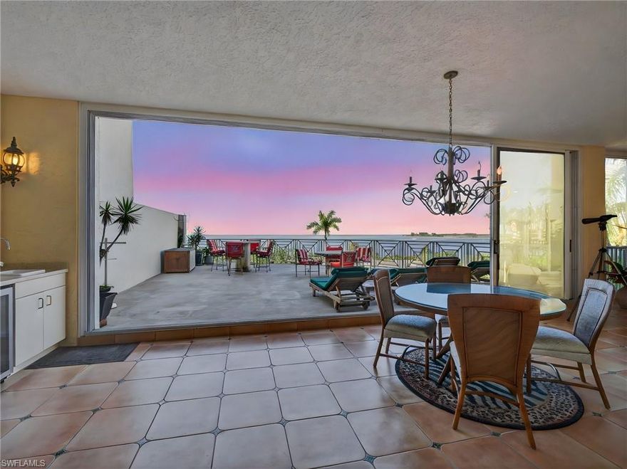 Experience the pinnacle of coastal living in this stunning three-bedroom, three-bath beachfront residence in Marco Island’s prestigious Riviera, located within the exclusive Hideaway Beach Club. Enjoy endless vistas of the Gulf of America and the Marco River from this recently renovated 4,050 sq.ft. condo, crafted with top-notch materials, superior craftsmanship and meticulous attention to detail. The state-of-the-art custom kitchen is a chef’s envy with features that include Ultracraft frameless lacquer-finished cabinetry, upper-level granite countertops, a prep island with pendant lighting, a six-seat breakfast bar with under-counter wine cooler, ice maker and beverage drawers. Appliances are all top-tier, including a Pro Series 48” Sub-Zero glass-front refrigerator with additional refrigerator, freezer, and ice maker drawers and an advanced water filtration system. The 36” convection oven, 36” induction cooktop, microwave, warming tray are all made by Wolf complimented by an illuminated vented exhaust hood, a Bosch dishwasher, farmhouse sink with Kinetico RO filtration system and a large walk-in pantry to complete this exceptional culinary space. Entertain guests in the formal dining area or on the adjacent screened loggia, perfect for morning coffee or evening relaxation enjoyed as either open-air or air-conditioned space. The main living areas showcase large-format travertine flooring, LED recessed lighting, plantation shutters, and designer chandeliers paired with modern ceiling fans for a refined coastal ambiance. Wake-up to breathtaking Gulf views from the primary suite, complete with a richly appointed en suite bath featuring dual vanities, a spacious walk-in shower, a private water closet with commode and bidet and a custom-fitted dressing room with extensive closet cabinetry. The guest suite, privately situated from the main living areas, offers its own en suite bath, walk-in closet, and private terrace. The third bedroom, currently serving as an office, enjoys panoramic Gulf views, sliding glass door entry to an expansive 577-SF terrace and easy access to the third full bath. The terrace, which can be enjoyed open-air or air-conditioned, includes a summer kitchen and leads to an extraordinary 711-SF outdoor patio, ideal for large gatherings or sunset entertaining. The condo is equipped with electric shutters, two (2020) A/C systems, two water heaters, an assigned Level-2 parking spot, a dedicated golf cart space, an extra owner garage space and two large storage closets. Hideaway Beach Club is a premier Southwest Florida beachfront community, offering a world-class lifestyle. Abundant amenities include a private executive golf course, a newly renovated beachfront clubhouse, a new wellness and fitness center, on-site formal dining room, ballroom, Sunset Lounge, and Sand Bar cafe. Residents also enjoy Har-Tru tennis courts, pickleball, bocce, and miles of nature trails through lush coastal preserves and a pristine beach. Make it yours!