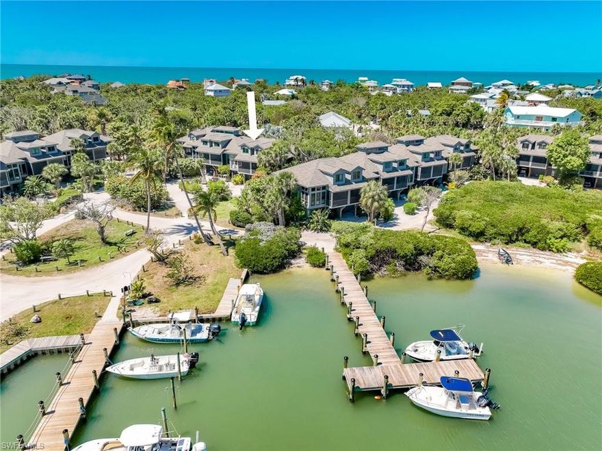 Priced to Sell!  Fantastic Views from this townhome located within the quaint waterfront boating community of Safety Harbor Club on North Captiva Island. Completely updated in 2025 with luxury finishes and decor, this townhome features modern coastal design, travertine marble floors, custom baths, elegant trimwork, and an open, light-filled layout that captures the serene harbor views. The thoughtfully designed interior features a sumptuous living room set with down-filled cushions, perfect for nestling in after a long day of beachcombing.  The main living area flows seamlessly to a covered screen porch where you can enjoy peaceful harbor breezes and sunrises while watching dolphins & boats pass by.  The kitchen and living spaces are ideal for entertaining or relaxing after a day on the water. The first-floor primary suite boasts a fantastic high-end resort feel, with an en-suite bath featuring a walk-in custom-tiled shower & glass enclosure, plus a separate commode room with a smart toilet/bidet. Upstairs, a perfect light-and-airy sleeping loft and a large guest bedroom share a completely reimagined & renovated bathroom, offering spa-like comforts like a deep-soaking claw-foot tub, chic tile, and a convenient curb-free shower area. On the ground level, the property offers a valuable bonus storage room and a dedicated golf cart garage, providing ample space for island gear, beach equipment, and convenient transportation.  Located close to the community dockage and ferry landing, this home is perfectly positioned for effortless island access and convenient boating. Ownership includes access to Safety Harbor Club amenities, featuring a heated pool, tennis and pickleball courts, clubhouse, beach access, and additional dock slips.  
North Captiva Island is a private barrier island known for its pristine beaches, preserved natural areas, golf-cart transportation, and relaxed lifestyle. Whether you are seeking a personal retreat, a perfect fishing rally point, a vacation getaway, or an investment property, this beautifully upgraded townhome offers an exceptional combination of location, upgrades, and lifestyle all at an affordable price.