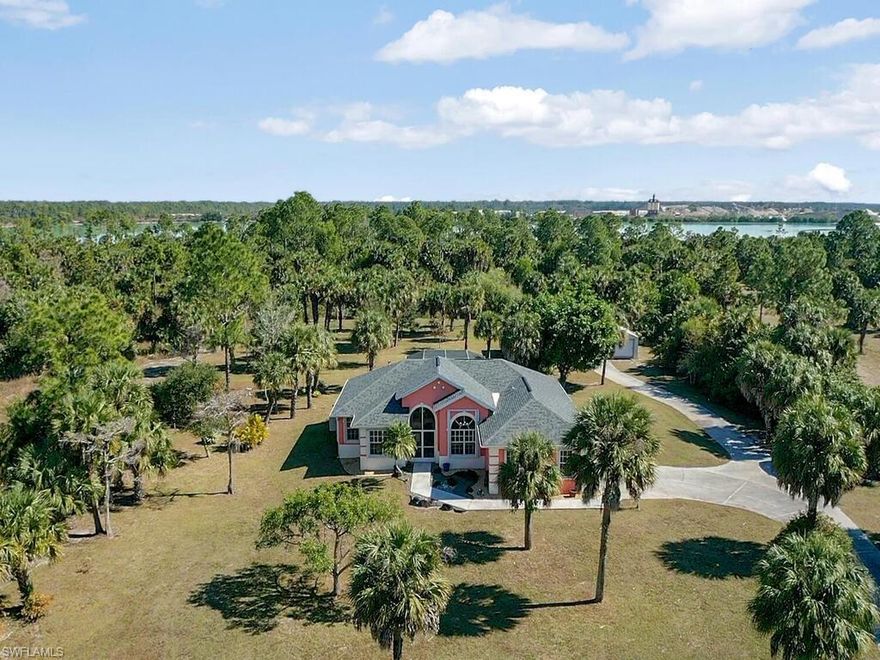Don’t Wait, there is so much you can do with this property!!! Imagine yourself opening the front door to your Estate Home, looking through the open living area, past the multiple glass French doors leading into the pool and spa with its own private outside shower and continuing on to your 7.07 acres, YES, 7.07 acres. This Exceptional open living concept home has 3-bedrooms, 2 baths, with a large walk-in closet in the master, a side loading 2-car garage bundled on your own 7.07 acres with a meticulously maintained country upland yard backing up to a quarry. This home has all the essentials and more. New roof, New A/C, upgraded Water Heater, Refinished Pool, custom large kitchen, stainless-steel appliances, remodeled large master bath, screened in pool & spa, a reverse osmosis system, large fire pit in an open and spacious backyard. This home comes with full Accordion, permanently installed hurricane shutters and a generator to power the home if needed. This property has 2 large sheds with power and one of them equipped with an A/C. This private retreat is close to schools, shopping and everything Naples has to offer. Perfect to enjoy with family and friends! This one won’t last!!!