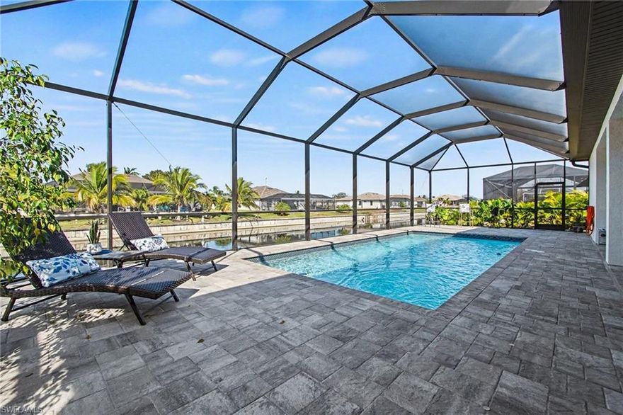 Welcome to your dream oasis! This stunning 3-bedroom, plus den, 3-bathroom furnished home boasts a spacious layout, complete with a large 3-car attached garage and a breathtaking view of the freshwater canal. Enjoy the peace of mind that comes with a brand-new seawall and take advantage of the extensive navigable canal system that is  perfect for fishing and boating adventures—all just 2 miles away from the prestigious Palmetto-Pine Country Club golf course.  Step inside to discover elegant tile plank flooring throughout, high ceilings, and impressive trey ceilings that enhance the open floor plan. The great room features an 8 ft pocketing sliding door that seamlessly blends indoor comfort with the lush outdoor surroundings. The kitchen is outfitted with quartz counters, stainless steel appliances, and real wood cabinets, making it a perfect gathering space.  Relax in the expansive covered lanai, equipped with an outdoor kitchen and surrounded by brick paver decking, ideal for entertaining or unwinding by the sparkling pool, which comes with a screened enclosure. The master bedroom is a place for relaxing and includes sliding doors that go out to the covered lanai and pool area. The master bathroom has dual vanities, and a custom shower with multiple shower heads, offering both luxury and practicality.  Additional highlights include a complete Smart Home, the front door, fans and appliances, lights, are all controlled by phone, a plug in set up for an electric car, expoxy floors in garage,all furniture less than one year old, impact-resistant windows for peace of mind, and the assurance that this home is located in a non mandatory flood zone. This exceptional property is not just a house; it’s a lifestyle waiting for you.  Don’t miss out on this incredible opportunity—your perfect home awaits!