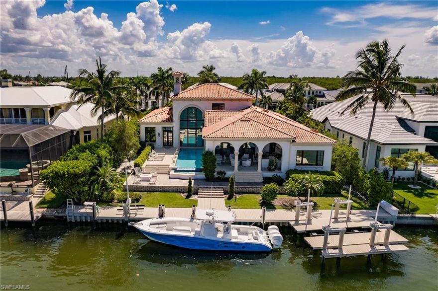 An idyllic, boaters dream in SWFL! This beautiful home offers the incredible view of Naples Bay with the privacy & protection of not being directly on the gulf. Not a boater? Entertaining is a breeze in this 4 bedroom + den home! Each bedroom has their own ensuite bathroom & with the show stopping sunsets your guests will be counting down the days until you invite them back. This furnished listing is beautifully decorated & furnished by award winning designers at Clive Daniel. The spacious outdoor area flows into the invisible edge pool & spa to create the perfect spot in paradise to soak it all in. This property also offers a 20,000 lb boat lift, jet ski lift, a seawall completed in 2020, & more than 100 feet of deep gulf frontage. Come soak in what this slice of paradise offers in person!