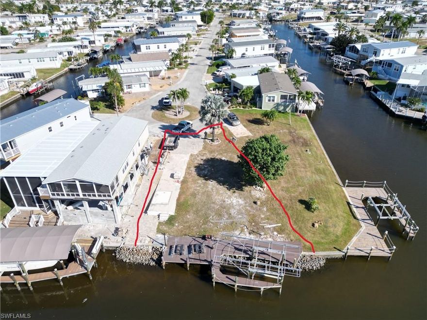 This amazing vacant lot sits at the end of the Cypress Lane Cul-de-sac and along the highly coveted deep-water channel. Although hurricane Ian claimed the life of former home, this lovely lot is ready for a new buyer to bring it back to life. It already has a very nice dock and boat lift. This lift has the aluminum ribcage on top, so you only need to reinstall a new fabric cover. This lot has approximately 75 feet of water frontage, allowing room enough for all your aquatic toys. It also sits on the saltwater side of Bayside Estates, so access to the gulf and your watery adventures is completely unencumbered--just get in your boat and go!!! Bayside Estates is the best kept secret of Fort Myers Beach. This incredibly active and friendly 55+ community is the crown jewel on the gulf coast. Bayside estates is only 2.5 miles to the beach and is accessible by either car or boat--right from either your driveway or private boat dock. Ride your electric bicycle to the beach for the day and visit the world-famous Jimmy Buffett’s Margaritaville. Just don't step on a pop-top!! Major retail vendors are within a very short driving distance for ultimate convenience. For those who don’t know a lot about Bayside Estates, it is a very fun place to call home---some would even say it’s a mature person’s playground. Whether you want to play pickleball, tennis or bocce ball, hang out at the community pool, skinny dip in your own pool, or simply cruise the hood in your swanky golf cart, there is always something going on around here. People are friendly and you will be warmly welcomed. Lot lines draw to pictures are approximate.