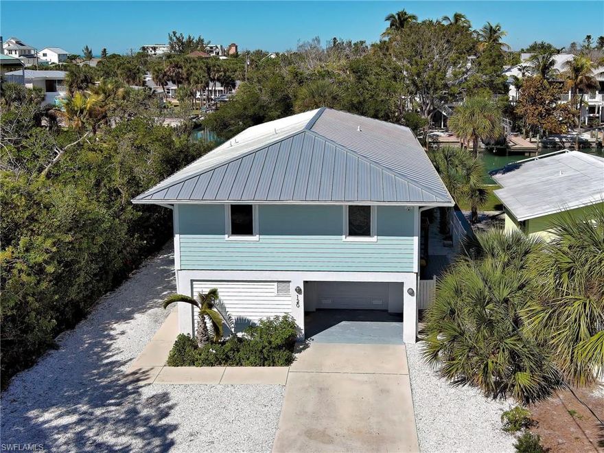 Exceptional canal-front home with deeded access to Englewood Beach, offering the best of Englewood’s coastal lifestyle. Ideally positioned with over 200 feet of canal frontage. The adjacent mangroves provide natural privacy uncommon on the Key. A setting that captures the quiet charm and beauty that makes Manasota Key so special. Updates include AC (2021), kitchen upgrades and appliances (2021), impact windows and sliding door in the living area upstairs (2022), storm-rated garage door (2024), a new 200-amp electric panel, and on-demand water heater (2025). Outdoor improvements feature Hardie board siding, a new deck and stairs, and reinforced soffit supports. Boaters will appreciate direct Gulf access with no bridges and a seawall, 10,000-lb boat lift and covered boat port that were all installed in 2022. A metal roof installed in 2021 adds additional peace of mind. Multiple outdoor living areas and an outdoor shower enhance the indoor-outdoor living experience. A rare opportunity to own a well-updated canal home on Manasota Key. Boat, fish, beach and relax- the best of Florida lifestyle!