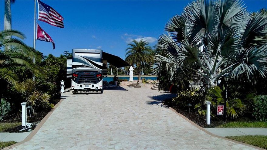 An exceptional Class A Motorcoach only lakefront property located in the prestigious Pelican Lake Motorcoach Resort.  The fully upgraded site is move-in ready. This rare end-lot offers enhanced privacy with only one neighboring site and easy access to the centrally located Clubhouse and resort amenities, making it a very desirable location in the community.
This expansive 5227 square foot property is fully finished with pavers throughout, including a raised lakeside patio featuring both steps and a ramp—perfect for seamless outdoor living, dining, and entertaining. Also upgraded with private, lush, mature landscaping with night lighting and a marine style pedestal. The elevated patio provides a stunning vantage point overlooking the wide, tranquil waters of the lake, creating on impressive expansive water views.
Coach house Details: 
A beautifully designed custom coach house (built in 2020) adds comfort, function, and value. At 308 square feet this coachhouse includes:
a full kitchen with range, dishwasher, & microwave and quartz countertops
a full spacious bathroom with large stand-alone shower
washer & dryer
a cozy living area with sliding glass doors opening directly to the large patio
 A functional loft for extra storage with library ladder for access