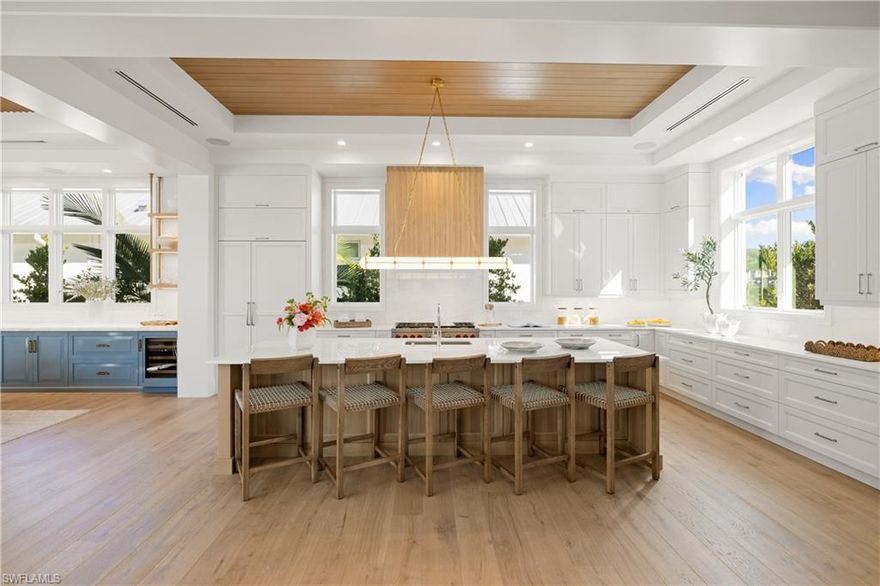 The market has spoken—and this exceptional Olde Naples residence is now strategically repositioned to capture immediate attention. Just completed and ideally located steps from Third Street South’s premier shopping and dining and moments to the white-sand Gulf beaches this newly constructed masterpiece delivers an unmatched blend of luxury, design, and lifestyle. A collaboration by Kukk Architecture, T. Jerulle Construction, Freestyle Interiors, and Scott Wyndham Landscape Architecture, the home reflects a level of craftsmanship and intentionality rarely seen. Spanning over 6,700 total square feet, the residence offers five private ensuite bedrooms, a dedicated office or den, private elevator, and a 3–6 car garage with lift capability—designed for both grand entertaining and effortless daily living. Architectural details set the tone throughout, from stained oak beams in the great room and primary suite to custom beam detailing in guest spaces. Wide-plank wood flooring with Francois & Co. herringbone inlays introduces warmth and texture, while designer lighting from Visual Comfort and Palecek creates a layered, curated ambiance. The kitchen is a true showpiece, featuring custom Goguen cabinetry, Cristallo quartzite surfaces, a Franke sink with Waterstone fixtures, and a full suite of Wolf, Sub-Zero, and Fisher & Paykel appliances—crafted for both function and statement. The primary suite offers a serene retreat with a spa-inspired bath appointed with Kallista fixtures, while a stunning dining room—complete with Ruffino cabinetry, backlit Cristallo, and Sub-Zero wine storage—sets the stage for unforgettable entertaining. A fully equipped party pantry ensures seamless hosting at any scale. Outdoor living is equally compelling. The expansive lanai features a custom fireplace, summer kitchen, dining and lounge areas, and a resort-style pool—creating a private tropical sanctuary. A refined coastal palette of sandy neutrals, soft grays, and tranquil blues flows throughout, reinforcing the home’s timeless, sophisticated aesthetic. Now offered at a newly adjusted price, this is a rare opportunity to secure a just-completed, design-forward residence in one of Naples’ most coveted locations. Repriced. Repositioned. Ready.