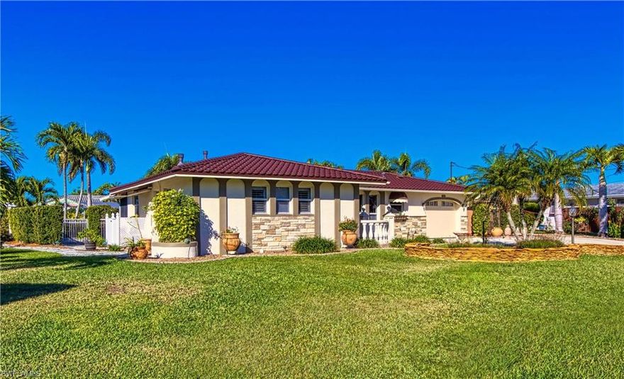 Welcome to 5266 Wisteria Ct in the heart of Cape Coral’s Yacht Club Area.  This stunning, well maintained and appointed home sits on nearly ½ acre of meticulously maintained park-like, land with 125 ft of canal frontage. Boaters and water enthusiasts will appreciate the quick access to the Caloosahatchee River and Gulf waters. Embrace the true outdoor living of SW Florida by enjoying private and secluded wonderland featuring a gorgeous free form swimming pool with fountain and waterfall. An oasis with courtyard, pergola, gazebo, arbors, Belgian cobble edge walkways, flagstone walls, lighting, vegetable/herb gardens and more. The outdoor setting sets the stage for the home itself, which features an open, flexible floorplan, high-end finishes and relaxed, light-filled rooms.  Natural stone travertine and luxury vinyl plank floors, exquisite granite and marble countertops, custom cabinetry, crown molding, 5-1/2” baseboards are just a few of the features of this unique and desirable home.  In addition to the spacious main suite and guest areas, you’ll certainly enjoy the large screened lanai and finished, air conditioned garage/bonus room (perfect for an office, exercise room, laundry, storage or anything else you can imagine).  New architectural metal roof in 2023. This home, and surrounding grounds, are truly breathtaking. Located just minutes from the lively downtown Cape Coral entertainment district, Cape Coral Bridge and the soon-to-be completely renovated Yacht Club.