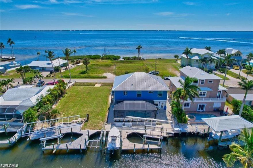 Your Slice of Paradise Awaits! Step into this fully furnished, turnkey waterfront masterpiece and prepare to be swept away by breathtaking panoramic views of Pine Island Sound and Sanibel Island. Nestled in one of Southwest Florida’s most coveted locations, this gulf-access pool home is a rare gem that blends luxury, comfort, and island charm. Interior Elegance Meets Coastal Chic Every inch of this home is thoughtfully designed with beachy, nautical décor that instantly transports you to vacation mode. The gourmet kitchen is a chef’s dream, featuring Cambria Quartz countertops, GE High-Profile stainless steel appliances, and a layout perfect for entertaining. Peace of Mind & Premium Upgrades Enjoy the security and style of a metal roof, impact-resistant windows and doors, plank tile flooring, and plantation shutters throughout. A new AC keeps things cool, while the shiplap lanai ceiling adds a touch of coastal sophistication. Outdoor Living at Its Finest Sip cocktails from your screened balcony as dolphins and manatees glide by. Take a dip in the heated saltwater pool, then unwind with the best sunsets in SWFL. With two covered boat lifts (14k & 7k lbs.), composite docks, and a fish cleaning station, your waterfront lifestyle is ready to launch. Island Adventures & Ultimate Convenience Hop in your included golf cart (valued at $20K and loaded with extras) and explore nearby amenities, or cruise to local islands and beaches for world-class fishing and relaxation. This is more than a home—it’s a gateway to the island life you’ve always dreamed of. Fall in Love. Move to Paradise. Whether you're seeking a serene retreat or a vibrant coastal lifestyle, this home delivers it all. Don’t just buy a house—claim your piece of paradise.