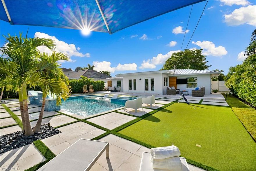 "WOW" FACTOR! Just blocks from the BEACH, this stunning turnkey 3 bed/2 bath home combines the luxury and convenience of new construction features with the old world charm of the classic Naples beach bungalow. Close to The Ritz and Mercato for dining & shopping, short drive to 5th Ave S! Gutted to the studs, every detail of this home was meticulously updated w/ the best materials and finishes, this home has the "it" factor! In-ground heated salt water pool with spa and plenty of space for lounging is the focal point of the private fenced and landscaped back yard. Kitchen w/ quartz island & countertops is the gathering place for this home, with room for a crowd at the dining room table & island seating. Chefs & guests alike will enjoy the S/S appl, gas stove, wall oven, island & side bar. Large living room w/ plush seating & screen TV for peaceful evenings. Large owner suite, 2 additional bedrooms w/ shared full bath. Paver circular driveway, new landscaping & lighting, new electrical & plumbing, new AC, new garage split AC, new roof, insulation, floors, and hurricane impact windows, insulated garage door, well water sprinkler system, buried 500 gallon propane tank, security system.