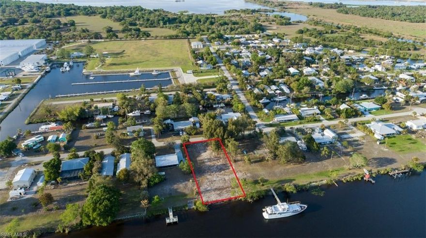 Discover Old Florida waterfront living at 1035 W Anchor Lane in the quiet boating community of Turkey Creek in Ortona. This over ½-acre riverfront homesite offers approximately 100 feet of frontage on the Caloosahatchee River and is located just east of the Ortona Locks, providing excellent access to the Intracoastal Waterway and Lake Okeechobee. Tucked at the end of a private dead-end street, the property offers privacy and a protected setting known by boaters as a natural hurricane hole. Electric is available and fiber-optic internet is in the area; well and septic required. Conveniently located between LaBelle and Moore Haven, this property is ideal for building your dream riverfront home in a peaceful boating and fishing paradise.
