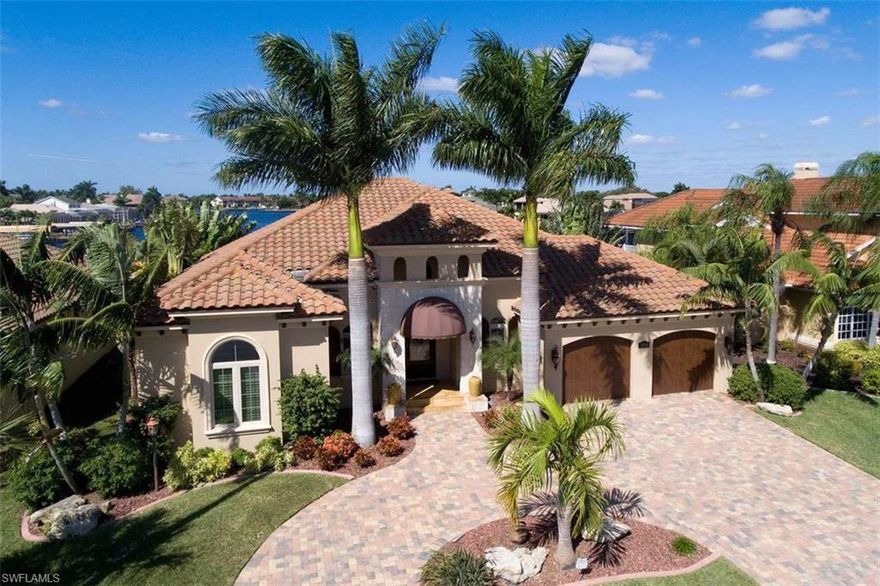 INCREDIBLE WATERVIEW, GULF ACCESS, CUSTOM BUILT HOME with TWO MASTER SUITES. From the second you walk thru the custom mahogany entry doors you’ll see the incredible 1/3 of a mile plus Water View. The custom floorplan offers approx. 2800 sq. ft. of indoor and 600+ covered outdoor living with outdoor kitchen and gas fireplace over-looking a vanishing edge pool & spa. The spacious kitchen has two islands, custom cabinetry, built-in refrigerator, oven & microwave, an induction cook top & wine cooler. Both master suites have 12' ceiling, pool & water view, walk-in closetswith custom built in cabinetry. The large laundry room has lots of custom cabinetry storage and second refrigerator that’s easily accessible. Other home features include 12' ceilings, 10' high sliding glass doors, 8' tall solid interior doors, crown molding and upgraded trim, awnings, vinyl clad windows and sliding doors. low E impact glass,  plantation shutters, french pattern stone flooring, paved circle drive,  boat dock with two lifts. This home is a must see to appreciate the numerous upgraded features offered by this “stunning” home. Schedule your appointment today.