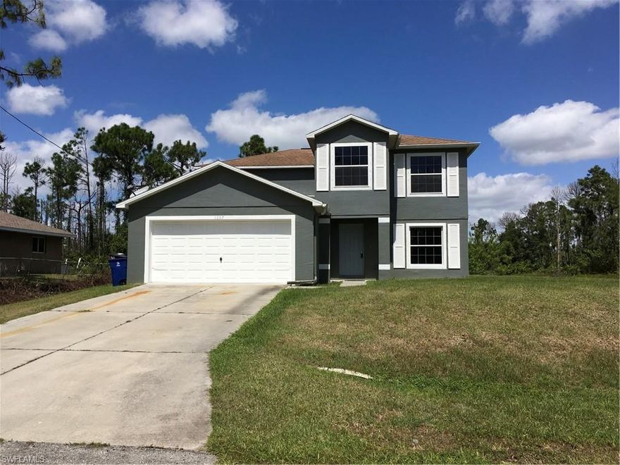Just Reduced. Owner says SELL!!! One of the lowest prices per sq ft of all Lehigh Acres  houses built after 2000. BIG FAMILY HOUSE 2766 Sq. Ft  4 bedroom 2 1/2 bath two car garage with 2 family rooms. completely remodeled. THIS LOOKS LIKE A NEW HGTV HOUSE ! Freshly painted grey and white inside and out with new grey wood floors. New kitchen w/granite tops,tile back splash,high end faucet and SS APPLIANCES.First floor dining room,open concept eat in kitchen/family room and master bedroom with full bath/granite/high end faucets on new double sinks.
UPSTAIRS ANOTHER FAMILY ROOM + three more bedrooms with remodeled bath / granite/new sink/high end faucet. All painted grey with white trim, wood floors downstairs and new berber carpet upstairs. THIS HOUSE IS BEAUTIFUL !