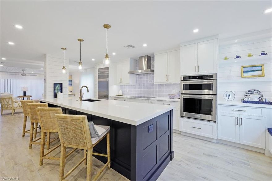 C7242. Fabulous townhouse situated in the heart of Old Naples. From the moment you walk through the doors you will feel at home in this beautiful calm retreat. Open floor plan with dream chef's kitchen, bar, window seat and an under-stair case area to put a desk, kids play area, reading nook (whatever!). Quantum White Quartz countertops are found in the kitchen, baths and bar area. Fisher & Paykel refrigerator and dishwasher, induction cooktop. First level is a hardwood look tile to match the French oak flooring on the stairs and 2nd story. Impact glass windows and sliders. Wonderful end unit with extra windows for light and air. Walkable to Third Street shopping and dining, the Gulf, City docks, Cambier Park and Crayton Cove. Roof replaced 2019. Parking pavers added 2020. Building exterior painted October, 2022. Carport parking with storage and an additional vehicle can be placed directly behind the carport (tandem).