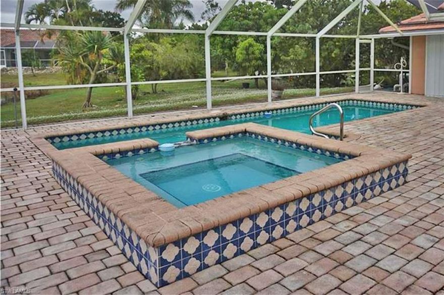 Waterfront home with Pool & Spa, private TENNIS COURT on over 2 Acres of very private property in the gated community of Bell Villa in Bonita Springs. This home sits at the end of the street and overlooks the Tennis Court and lake. Very private setting with a paved driveway, pool deck and patio. The are 3 bedrooms and 3 full bathrooms , 2 attached car garage , tile floors throughout, real wood fireplace, kitchen pantry, new tile roof , new air conditioning unit, accordion shutters on all windows and roll-up shutters on under trust lanai, a metal shed in the back yard and many fruit trees: mango , star fruit, papaya, great fruit. Master bathroom has dual sinks , tub and shower. Full recreational facilities, including softball teams, are available through the Citrus Park Association for a very nominal fee. Minutes to Bonita Springs, Ft. Myers and Naples world class beaches, boating, shopping, preserves and Southwest Florida International Airport (RSW) plus all the other great amenities found in Southwest Florida. The lot on end of Segovia is 0.99 acres (151 x 290) is included in price. Seller motivated! Bring offer!