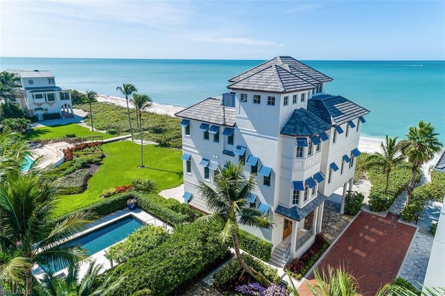 Direct beachfront, coastal contemporary masterpiece with RARE PRIVATE POOL offered in North Naples’ coveted “Barefoot Beach” gated community! Delight in panoramic Gulf views from Naples to Sanibel, on a rare double lot with private Gulf-access boat slip available (enjoy a 10-minute scenic ride to the Gulf). This recently constructed state-of-the-art home is the ONLY direct beachfront home available in Barefoot or Bonita Beach. Custom-curated by renowned Windover Development with award-winning Potter Homes, Kukk Architecture & Freestyle Interiors. The oversized resort-style saltwater pool offers ample lounging space, water fountains & privacy landscaping surrounding. This spacious architectural marvel has a fantastic open floor plan with dual master suites & chef’s kitchen offering custom cabinetry, premium granite counters & Wolf, Bosch & Subzero appliances. The main living room boasts automatic corner sliders on both the South & West sides, and when opened with the touch of a button, seamlessly brings the beach to your fingertips. Features all impact glass windows/sliders, electric screens/lanais, smart lighting, surround sound, elevator & more. A showcase of visionary design.