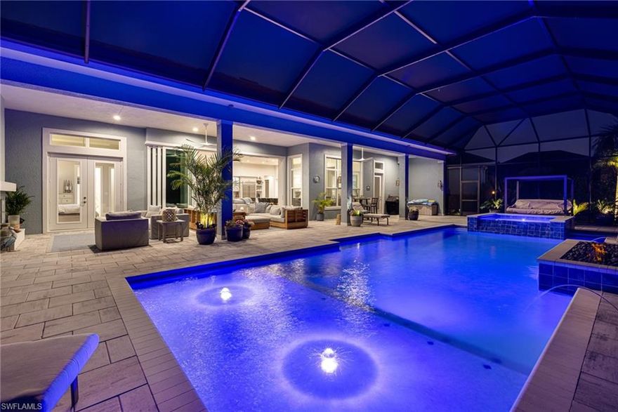 Set within the prestigious, resort-inspired community of Naples Reserve, this exceptional lakefront residence delivers refined luxury, thoughtful design, and a setting that feels both private and serene. Offering three bedrooms plus a den, three beautifully appointed baths, and a three-car garage, the home showcases elevated craftsmanship and an effortless flow for modern coastal living. Tranquil water views frame the main living areas, while pocketing glass doors open to an expansive screened lanai that serves as a true extension of the home. This exceptional outdoor retreat features a heated saltwater pool and spa, a fireplace, and additional fire features—creating a warm, resort-like ambiance ideal for entertaining or unwinding under the stars. Southern exposure fills the space with natural light throughout the day, and the peaceful lake setting offers one of the most private and picturesque backdrops in the community. Inside, a contemporary open floor plan pairs clean architectural lines with inviting, well-proportioned spaces, enhanced by generous ceiling heights, refined finishes, and an emphasis on light, scale, and livability that elevates everyday moments. The gourmet kitchen anchors the home with premium appliances, custom cabinetry, and seamless flow into the living and dining areas—perfect for both casual gatherings and elegant entertaining. The primary suite is privately positioned to capture calming water views and features a spa-inspired bath designed for comfort and relaxation, while guest accommodations are thoughtfully separated to ensure privacy. A versatile den provides flexibility for a home office, media room, or guest retreat. Designed with the future in mind, the property includes plumbing and electrical connections along with a buried 500-gallon tank for a future outdoor kitchen, and it is eligible for a private boat dock—an exceptional opportunity within Naples Reserve. Residents enjoy a vibrant, amenity-rich lifestyle with a clubhouse, lagoon-style pool and beach, tiki bar, fire pit lounges, fitness center, on-site dining, tennis and pickleball courts, bocce, volleyball, playgrounds, dog parks, Kids Cove, a community garden, miles of scenic trails, watercraft, and the community’s signature Kontiki Island. Just minutes from Naples’ renowned beaches, Fifth Avenue shopping and dining, boating, and everyday conveniences, this home is more than a residence—it’s a private retreat offering a rare balance of luxury, privacy, and lifestyle in one of Naples’ most sought-after communities.