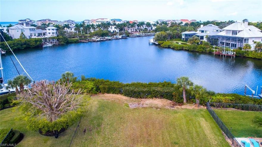 Spectacular Gulf-access lot located in the double-gated “Bayfront” neighborhood of Collier County’s premier “Barefoot Beach” community. This oversized .38-acre parcel is the crown jewel lot of Barefoot Beach. Best of both worlds – Beach & Boating! Boasts a fantastic wide bay view with the possibility for views of the Gulf from a top floor viewing deck. Enjoy Gulf-access from your future boat lift in 10-15 minutes through Wiggins Pass. Offers both the width and depth to support a stunning luxury home, just a short walk to one of two deeded Barefoot “resident-only” beach accesses. Bayfront Drive homes are only built on one side of the street, providing homeowners not only spectacular bay views, but also preserve views with ultimate privacy on the opposite side. The OPTIONAL in-community “Club at Barefoot” is currently undergoing substantial upgrades & offers tennis, 2 restaurants, beachside food/bev/chair service & activities. Barefoot Beach is perfectly located minutes to several highly rated local restaurants, 15 minutes to Mercato & has easy access to RSW International Airport & 5th Avenue Naples.
