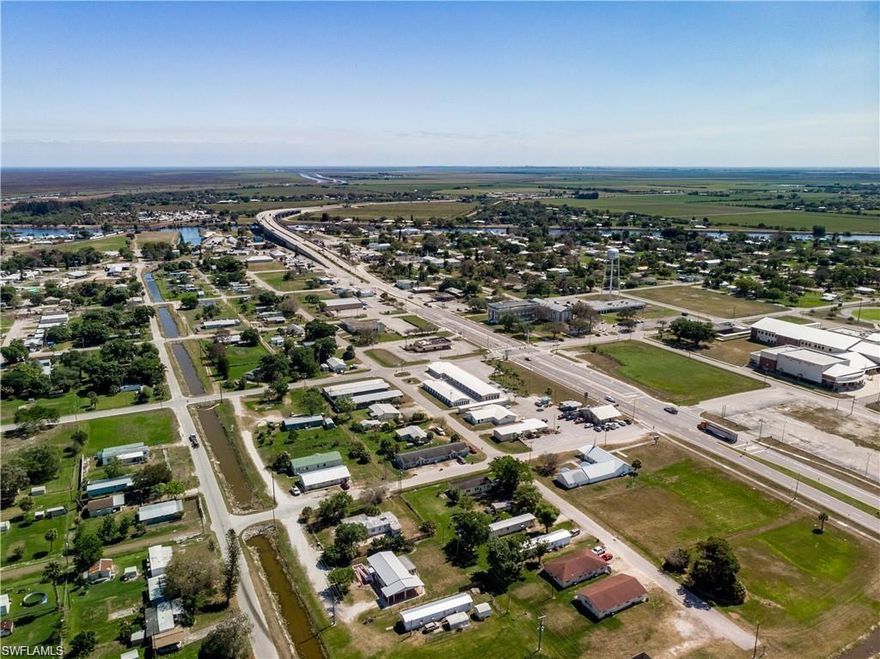 LOCATION LOCATION LOCATION!! This is an EXTRAORDINARY OPPORTUNITY to purchase 2 Acres of PRIME COMMERCIAL PROPERTY with approximately 350 FEET of frontage on U.S. Highway 27 in Moore Haven, FL. This parcel is ideally located adjacent to the Glades County Courthouse and directly across the street (to the north) from Moore Haven High School. The property is zoned C-2 which allows for a wide variety of commercial businesses which include, but not limited to, RETAIL STORES, BANKS, RESTAURANTS (including drive-through), HOTELS/MOTELS, AUTOMOTIVE SALES, SELF STORAGE FACILITIES, CONVENIENCE STORES, and GAS STATIONS.