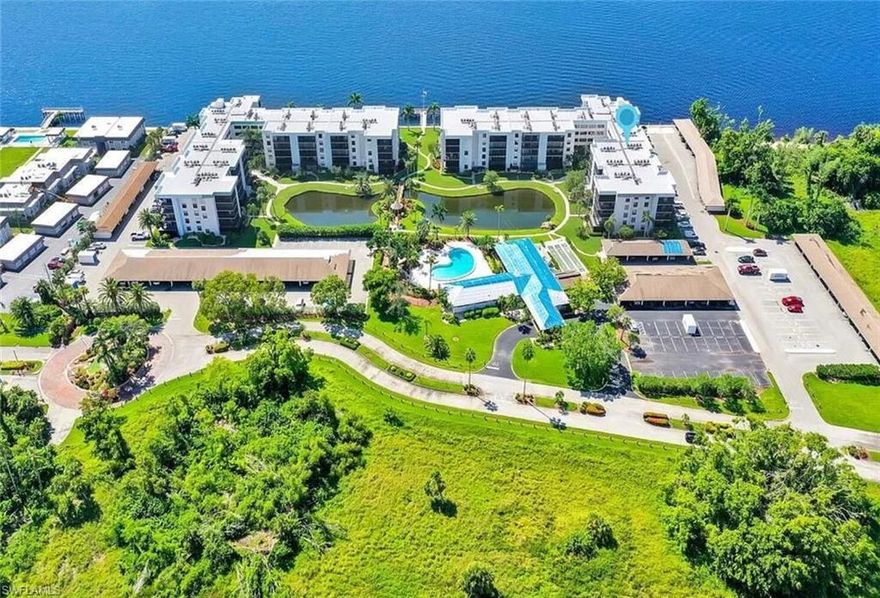 AWESOME 2/2 RIVERFRONT CONDO!   Your rent INCLUDES: water, cable, Wi-Fi, and pest control.  ALSO ALL community amenities: resort-style heated swimming pool, billiards room, gym, sauna, BBQ grills, fishing pier, and shuffleboard. YOU WILL LOVE LIVING IN THIS WONDERFUL AFFORDABLE GATED COMMUNITY THAT SITS ON Caloosahatchee River.  Relax and watch the dolphins from community dock, view over River to downtown River district just over the bridge to Ft. Myers. It's waterfront resort style living with fitness room, pool, game room, private pier with fishing station, walkways, BBQ areas. It's a short walk to Marinatown with tiki-hut restaurants, kayak rentals, and boat tours. Available June 2026 .  Spacious great room overlooking beautiful pond, pool, clubhouse, water bridge and waterfall. Awesome modern kitchen that has breakfast bar that opens into living area. Separate dinning area. Bedroom 2 also opens onto screened tiled lanai, large primary bedroom with walk-in closet, and private bathroom, stackable washer/dryer also included, private assigned carport with another large storage room for pool and beach gear. Just a quick commute to the historic downtown Fort Myers area or the beaches, or walk next door to waterfront restaurants. During the season, enjoy complimentary trolley rides to downtown. What are you waiting for? Don't let this opportunity slip away. Schedule your showing today, and let's turn your Florida dreams into reality! The North Key Peninsula is gated and associations requires background check. No Smoking. No Pets. Downtown Ft Myers is just across the SR-41 bridge over Caloosahatchee River, a very easy commute/drive for work or pleasure. Association's Renter Application Fee is $100.  Call today for your personal showing appt.