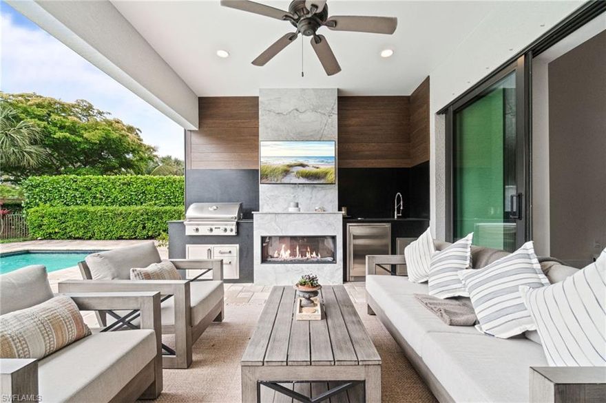 Welcome to 16201 Camden Lakes Circle, where thoughtful upgrades and refined design elevate everyday living in one of North Naples’ most conveniently located, sought-after communities. This beautifully enhanced Dartmouth II model showcases wide-plank oak flooring throughout, creating a warm, cohesive foundation that complements the home’s modern organic aesthetic.  The main living spaces are accented with designer lighting from Restoration Hardware in the kitchen, dining, and living areas, adding a sophisticated, curated feel. The heart of the home is the kitchen, and this one is no exception, featuring a large island, 5-burner gas range, wall oven and microwave, an upgraded wine and beverage bar with a dual-zone wine refrigerator, and a walk-in pantry. Zero-corner sliding doors create a seamless transition to indoor-outdoor living, where a spectacular custom retreat awaits in your private, fenced backyard. Enjoy your private saltwater pool and cold plunge, surrounded by a thoughtfully designed outdoor living space anchored by a marble fireplace—perfect for entertaining or relaxing evenings. The all-season outdoor kitchen includes a built-in grill, sink, refrigerator, and striking soapstone countertops. MagnaTrack retractable motorized hurricane screens provide peace of mind and protection without compromising the view. The floor plan offers spacious accommodations for both owners and guests, ensuring comfort and privacy, with each bedroom featuring a dedicated bathroom and walk-in closet. The owner’s suite boasts tranquil backyard views, a seating area, and an upgraded spa-like bathroom with dual vanities, a separate shower and soaking tub, and a luxurious custom closet system. A flexible den can serve as a home office, meditation space, or additional guest accommodations. Amenities geared toward wellness and lifestyle abound. The garage has been transformed into a multifunctional space with a fully equipped home fitness area, including a Peloton, Smith machine, and free weights, along with a private sauna for ultimate relaxation—all while still accommodating parking for two vehicles. The home’s curb appeal is enhanced by custom landscape lighting in both the front and backyard, highlighting the architecture and lush surroundings long after sunset. 16201 Camden Lakes Circle offers a rare opportunity to own a move-in-ready home with high-end upgrades designed for comfort, style, and wellness—all in a prime Naples location close to beaches, dining, and shopping.