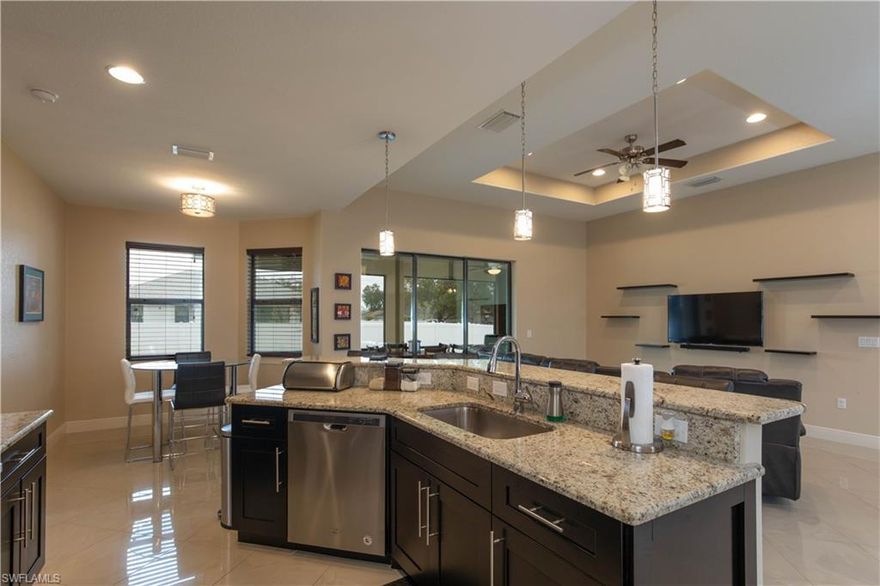 This gorgeous 3/2 home is better than new with title insurance and doc stamps paid by Seller, window coverings in place and a fully fenced yard with 6' vinyl fencing. This home built in 2017 boasts many upgrades over builder basics like 8 foot doors, large format porcelain tile throughout the entire house, tray ceilings, stainless appliances including a French door refrigerator, upgraded cabinets, full slab kitchen island with large deep sink, upgraded lighting fixtures, upgraded modern fans, tile tub surrounds to the ceilings, granite tops in both baths, many recessed ceiling lights and a 44 foot long paver driveway for ample parking. Location is in a quiet neighborhood with many newer homes and is within 5 minutes to shopping and dining destinations. No flood insurance is needed at this address. If you're thinking of building a new home you owe it to yourself to schedule a visit and see this one with your favorite Realtor soon!!! Assessments are in and paid in full!!! 3 Golf Courses nearby! Call today!