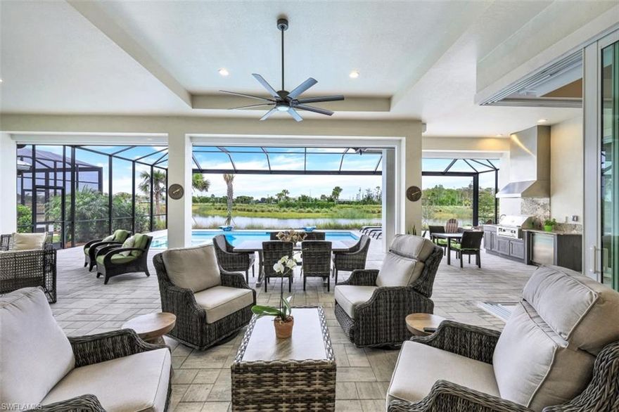 H8410. Immaculately maintained Madison II model showcases, 4 bedrooms plus a den, 4 1/2 bathrooms and coastal modern design and decor. Residence is an entertainer's dream with expansive resort-style pool/spa, multiple outdoor living areas, summer kitchen, and panoramic wide water lake views. Walls of pocketing and zero/corner entry glass sliding doors provide easy access from the exterior outdoor entertaining areas to the living room and chef's kitchen with gas cooktop, high-end appliances and over sized island with seating area. Escape to the inviting owner's retreat and relax in the spa like soaking tub or oversized walk in shower. Home is offered with current, beautiful and comfortable furnishings and accessories - turnkey for your convenience. Residence is finished with three car, garage, beautiful fixtures and gorgeous flooring. The Isles of Collier Preserve is a gated community with amenities including, pickleball, tennis, kayaking, enormous fitness center, lap and resort pools, Key West style Bar and grill, over 8 miles of walking trails, and is located less than five miles to the beach and just minutes to downtown 5th Avenue!