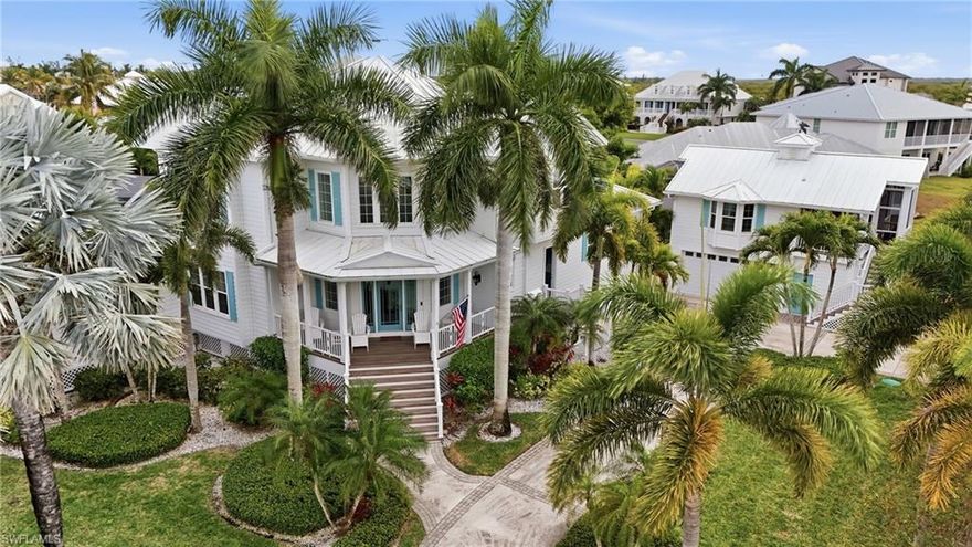 Located on Millionaires Lagoon in Tidewater Island, this 6-bedroom, 5-bath Key West–style waterfront residence sits on one of the community’s largest lots—a rare half-acre plus .62, southern-facing homesite tucked away on a quiet cul-de-sac within an exclusive, gated boating community. A true boater’s dream, the property offers canal-front living with direct Gulf access, a private dock, and a 16,000-lb boat lift, placing Lovers Key Beach just 15 minutes away by water.

Upon entry, soaring ceilings and abundant windows fill the home with natural light, highlighting the island-inspired design and elegant hardwood flooring throughout the main living areas. The spacious family room opens seamlessly to the first-level deck, while the dining area connects to a covered outdoor deck, ideal for effortless indoor-outdoor entertaining. The updated kitchen features quartz countertops, a breakfast nook, Thermador double ovens, and a side-by-side refrigerator, complemented by ROHL water fixtures throughout.

The first-floor owner suite has been fully remodeled, providing a private retreat with a spa-like en-suite bath featuring dual quartz vanities, a walk-in shower, soaking tub, and a generous walk-in closet. A large first-floor laundry room with built-in cabinetry and a farmhouse sink adds convenience and charm.

Upstairs, four spacious guest bedrooms with large walk-in closets are complemented by two full bathrooms and private balconies overlooking the pool and lush garden views

Recent upgrades include a brand-new metal roof, Royal Celect composite siding throughout the home, PGT impact windows, Pella doors, all-new PEX plumbing, a new water heater, and new foam attic insulation in both the home and garage delivering modern efficiency and long-term peace of mind. Designer lighting and ceiling fans throughout enhance the refined coastal aesthetic.

Outdoor living is exceptional, featuring expansive decking for entertaining and relaxation. The 20’ x 40’ resort-style pool and spa have been fully updated with a PebbleTec finish, crushed seashell stone pavers, a 360-degree picture-window lanai cage, new screens, and a convenient auto-fill system. Step directly from the pool deck to your boat on the lift. Additional highlights include a wood-burning fireplace and a built-in grilling area.

Completing the estate is a fully remodeled detached guest house, contributing to the home’s six bedrooms and five bathrooms, located above a two-car garage and workshop. This private retreat features new PGT impact windows, updated flooring, a new kitchen with quartz countertops, one bedroom and full bath, a charming screened porch, and a mini-split system with separate zones providing heating and cooling to both the guest house and garage ideal for guests.

An exceptional opportunity to own a six-bedroom, five-bath waterfront estate with direct Gulf access, unmatched lot size, and resort-style living in one of the area’s most desirable gated boating communities.