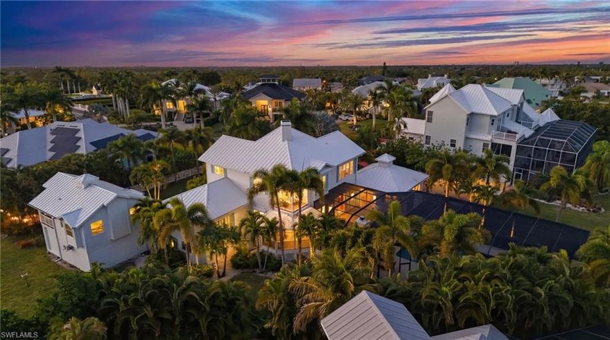 Located on Millionaires Lagoon in Tidewater Island, this 6-bedroom, 5-bath Key West–style waterfront residence sits on one of the community’s largest lots—a rare half-acre plus .62, southern-facing homesite tucked away on a quiet cul-de-sac within an exclusive, gated boating community. A true boater’s dream, the property offers canal-front living with direct Gulf access, a private dock, and a 16,000-lb boat lift, placing Lovers Key Beach just 15 minutes away by water.

Upon entry, soaring ceilings and abundant windows fill the home with natural light, highlighting the island-inspired design and elegant hardwood flooring throughout the main living areas. The spacious family room opens seamlessly to the first-level deck, while the dining area connects to a covered outdoor deck, ideal for effortless indoor-outdoor entertaining. The updated kitchen features quartz countertops, a breakfast nook, Thermador double ovens, and a side-by-side refrigerator, complemented by ROHL water fixtures throughout.

The first-floor owner suite has been fully remodeled, providing a private retreat with a spa-like en-suite bath featuring dual quartz vanities, a walk-in shower, soaking tub, and a generous walk-in closet. A large first-floor laundry room with built-in cabinetry and a farmhouse sink adds convenience and charm.

Upstairs, four spacious guest bedrooms with large walk-in closets are complemented by two full bathrooms and private balconies overlooking the pool and lush garden views

Recent upgrades include a brand-new metal roof, Royal Celect composite siding throughout the home, PGT impact windows, Pella doors, all-new PEX plumbing, a new water heater, and new foam attic insulation in both the home and garage delivering modern efficiency and long-term peace of mind. Designer lighting and ceiling fans throughout enhance the refined coastal aesthetic.

Outdoor living is exceptional, featuring expansive decking for entertaining and relaxation. The 20’ x 40’ resort-style pool and spa have been fully updated with a PebbleTec finish, crushed seashell stone pavers, a 360-degree picture-window lanai cage, new screens, and a convenient auto-fill system. Step directly from the pool deck to your boat on the lift. Additional highlights include a wood-burning fireplace and a built-in grilling area.

Completing the estate is a fully remodeled detached guest house, contributing to the home’s six bedrooms and five bathrooms, located above a two-car garage and workshop. This private retreat features new PGT impact windows, updated flooring, a new kitchen with quartz countertops, one bedroom and full bath, a charming screened porch, and a mini-split system with separate zones providing heating and cooling to both the guest house and garage ideal for guests.

An exceptional opportunity to own a six-bedroom, five-bath waterfront estate with direct Gulf access, unmatched lot size, and resort-style living in one of the area’s most desirable gated boating communities.