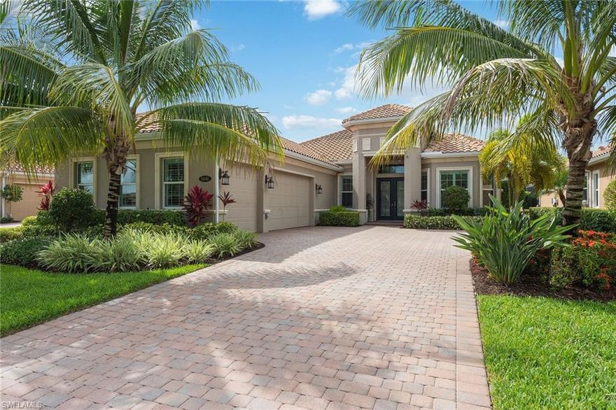 Fabulous resort-style living awaits in this lovely lakefront, 3-bedroom, plus den, 3 1/2-bath home in Lagomar in Fiddler's Creek. Bring the outdoors in with sunny southeastern exposure, triple pocketing and impact glass sliders that open to a spacious lanai with panoramic screens, saltwater pool with waterfall, spa and summer kitchen perfect for entertaining. Interior highlights tray and coffered ceilings, crown molding, plantation shutters, tile and wood floors and neutral decor. The Washington floor plan features a den, formal dining room, expansive great room connecting the kitchen, breakfast nook and butler's pantry with wine cooler and walk-in pantry. Fantastic chef's kitchen with large granite island, prep sink, custom 42-inch cream-colored cabinets, gas cooktop and stainless steel appliances. Luxurious master suite with private lanai access, large walk-in closet, en-suite with dual sinks, tile shower and enclosed WC. Two additional en-suite bedrooms for guests' privacy. Smart home technology, Tesla charging plug-in, insulated AC garage. Tankless water heater, portable generator hookup. Storm Smart hurricane protection on front door and lanai. CDD bond paid in full.