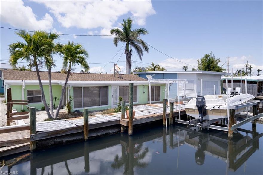 Discover your slice of paradise in the quiet fishing town of Matlacha Island.  This charming 2 bedroom 1 bath home offers the perfect blend of island character and modern comforts. This home is a boaters dream with direct access with wood dock and boat lift out back along with a kayak rack for those AirBNB guest or avid fishermen. Step inside to an open & split floor plan with plenty of light. Newer roof, New cabinets and A/C with tile flooring throughout. Whether you're looking for a full time residence, vacation getaway, or investment opportunity, this Matlacha waterfront gem has it all for under 325k!! Nestled in prime location and walking distance to shopping, art galleries and restaurants, and just a short drive to Cape Coral & Fort Myers, this is a true old Florida Living with modern day convenience.