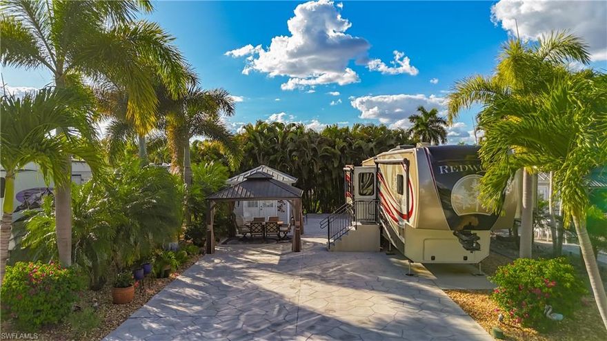 Welcome home to 10449 Nightwood Dr. Lot C77. Very well maintained and landscaped lot with extra concrete on the side to park your RV. This allows for a spacious lay out with gazebo in front of the accessory building.  This full service accessory building has refrigerator, washer, dryer, toilet, shower and sink.  Cypress Woods RV Resort is a luxury resort with a Welcome Center and a Town Center.  Welcome Center has a laundry area, card room, and day spa.  the Town Center has a large great room for entertainment with catering kitchen, card room, and community room.  Both areas have pools and hot tubs for your enjoyment.  This is a gated friendly resort that has many amenities including tennis courts, pickleball, hot tubs, pools, shuffleboard and much much more.  Conveniently located close to all South West Florida has to offer.