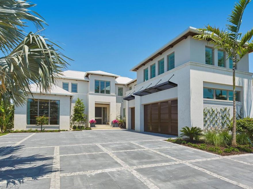 London Bay redefines luxury and encapsulates the essence of Naples’ exclusive Port Royal lifestyle in this stunning waterfront estate, which boasts 107 feet of Hidden Bay shoreline and direct access to the Gulf of Mexico. The estate’s architecture, designed by the acclaimed Kukk Architecture & Design, makes a bold statement and includes all the necessary amenities for stylish entertaining. Interior design, furnishings, finishes, and custom selections by Romanza Interior Design create a unique palette that balances elegance and effortless living. The soft contemporary aesthetic features limestone floors in the main living areas and pewter white oak wood flooring in the primary suite, study, and throughout the second floor. The open floor plan captivates with expansive living spaces, all offering beautiful bay views. Pocketing Weiland lift-and-slide doors seamlessly extend the spacious great room, kitchen, and dining area to both covered and open-air alfresco living spaces with uninterrupted flush flooring. The kitchen is tailored with Poliform cabinetry and an oversized island, a Galley workstation sink, and a built-in table for casual dining. The elegant primary suite includes an impressive gallery and a boutique-style oversized Poliform walk-in closet with custom Casali doors. Featuring luxurious dual baths connected by a shared shower, this light-filled suite boasts walls and ceilings adorned with Venetian plaster and floor-to-ceiling glass leads to a tranquil outdoor retreat. The second floor offers a VIP suite and three spacious en-suite guest rooms, as well as a dedicated exercise studio and a second laundry room that encircle a well-appointed loft. The loft features a morning kitchen and sliding glass doors that open to a bay-facing balcony. The covered lanai provides outdoor living, dining, and a large well-equipped kitchen for entertaining. Water cascades from the raised spa into the infinity edge pool’s sun shelf, which is connected by stepping stones leading to a sunning deck and a secluded lounge with a fire table. The estate also includes the conveniences of an air-conditioned three-car garage, elevator, and a generator. Eligible for Port Royal membership.