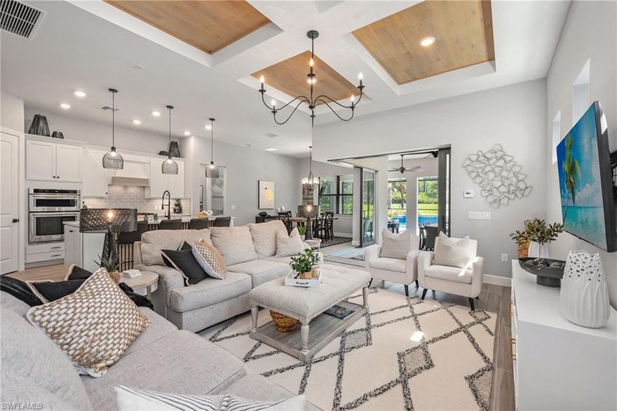 This masterfully designed three-bedroom, three-bath residence with den comes turnkey furnished in the award-winning community of Fiddler’s Creek. When you enter, you are greeted by 10-foot ceilings, 8-foot doors, impact-resistant windows and wood plank tile flooring throughout. The luminous white kitchen with quartz countertops, glass tile backsplash, large four-seater island and walk-in pantry is equipped with KitchenAid appliances, crowned by a gas cooktop. The adjacent living room features a wood plank coffered ceiling and zero corner pocketing sliding glass doors leading to an expansive screened-in lanai outfitted with electric storm shutters. Here, an outdoor kitchen with herringbone subway tile wall sets the stage for unforgettable gatherings. Dine alfresco and retreat to the sitting area for relaxation or lively conversations. The focal point, however, is the heated pool, complete with a sun shelf and adjoining spa. Fiddler’s Creek residents enjoy luxury amenities that include a resort-style pool, championship golf, fitness center, tennis, pickleball, bocce, spa, sauna, fine and casual dining, social activities and 24/7 security. Golf, beach and marina memberships available.