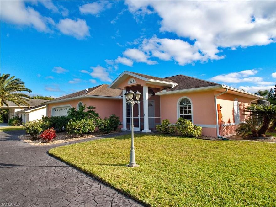 The stunning beauty and serenity of this Lehigh Acres home will catch your eye and capture your heart! It has been built onto a vividly landscaped, oversized lot on a Cul-de-sac with no through-traffic; it’s edging on a canal where turtles play, and beyond is only nature. The yard is artfully adorned with mature landscaping and invites you to stroll around your property as you would a botanical garden.
You will find the interior of this 3 BR/2B home just as captivating as its exterior. It’s spacy and bright, it has a split floor plan, and it has been designed for maximum comfort and optimal vistas. Open the big sliding doors and enjoy the sparkling beauty of the oversized (32x15), solar heated pool. The large pool-area is accessible from the living area, the master-bedroom, and both bathrooms, which allows you to use them as pool-baths. 
The house can be sold turn-key if so desired and would make a great vacation home. All new exterior paint in 1/2022.