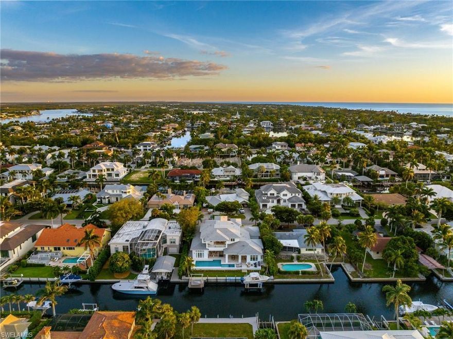 Built in 2022 and never lived in this extraordinary custom-built waterfront, like new, home is situated in Aqualane Shores offering quick and direct deep access to the Gulf of Mexico. With over 8100 total Sq.Ft. of living space, this home's open floor plan offers incredible indoor/outdoor living spaces, five bedrooms, each with en-suite bathrooms, offering privacy and convenience for residents and guests, whole house generator,  pool and powder baths, and a private elevator. The first floor features two master suites with luxurious walk-in showers, free-standing soaking tubs, dual sinks, and a vanity area. Modern design and décor can be found throughout the home, showcasing floor-to-ceiling windows, pocketing sliders, a 2nd-floor wet bar and relaxation area, and a true chef’s kitchen with top-of-the-line appliances. Entertaining is a breeze with expansive outdoor living encompassing an amazing pool and spa, a full kitchen with a gas grill, bar seating, a dining area, and an outdoor fireplace. This location is highly desirable, with a short walk to the beach and the historic Third Street South shopping and dining district. Despite its accessibility, the property is situated on a quiet, non-through traffic street. Overall, this waterfront luxurious home is a well-appointed property, offering a comfortable and elegant Florida lifestyle.  Only 899 steps to the beautiful white sandy Naples beach!