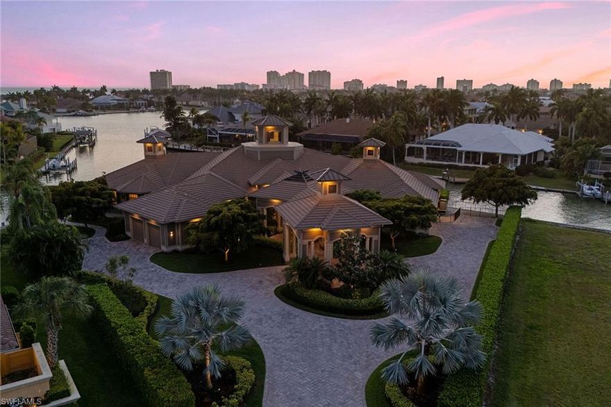 Nestled in the prestigious Estates area of Marco Island, this extraordinary water-direct home is a true gem. Situated on one of the largest tip lots, boasting over 300 feet of water frontage, it offers unparalleled access to the open Gulf waters in mere minutes.
 
 Built in 2014, this meticulously crafted home spans over 5,700 square feet under air and a total of more than 10,000 square feet. Every detail has been thoughtfully designed with no expense spared, creating an exquisite living experience.

 The grand porte-cochere entrance sets the tone for this architectural marvel. Inside, the great room is a showstopper, featuring a soaring cupola and vaulted ceilings that flood the space with natural light.

 The gourmet kitchen is a culinary dream, equipped with top-of-the-line appliances, including two Sub-Zero refrigerators, Wolf appliances, and two dishwashers. Quartz countertops and custom-built buffets seamlessly connect the kitchen to the elegant dining room, perfect for entertaining.

 This home offers 5 bedrooms, each with its own en-suite bathroom, plus 2 additional half baths. Notable amenities include a state-of-the-art movie theater, a massive wine room, 2 laundry rooms, and ample storage.

Step outside to the expansive lanai, complete with an outdoor kitchen, two fireplaces, electric screens, and hurricane shutters. The outdoor space is designed for luxury living, with two boat docks featuring lifts, jet ski lifts, and easy Gulf access.
Complete with 4 car spaces (two 2-car garage each with room for lifts, and whole house generator!

This is an unparalleled opportunity to own a piece of paradise in Marco Island, combining luxurious waterfront living with every imaginable modern comfort.