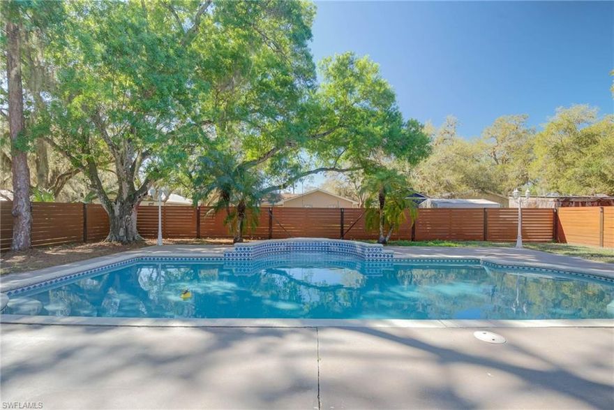 *ACCEPTING BACK-UP OFFERS*BEAUTIFUL 4 BEDROOM, 2 BATHROOM HOME WITH POOL AND BACKYARD FENCE—YOUR NEW HOME OASIS!! In the heart of Labelle, Florida, surrounded by majestic oak trees, this home offers a peaceful retreat with modern comforts and timeless charm. Step onto the inviting front porch, perfect for enjoying your morning coffee. Inside, you’ll find a well-appointed kitchen featuring granite countertops, stainless steel appliances, and an island—ideal for meal prep and entertaining. The open layout flows seamlessly into the living area, and French doors lead out to the backyard, where you can enjoy the heated pool and your private oasis. For added convenience, the home includes a designated laundry room. The spacious lanai, covered and overlooking the pool, provides a comfortable spot to relax. With a brand-new A/C unit (installed in 2024) and a water heater replaced within the last 5 years, this home offers modern updates and peace of mind. The durable metal roof ensures long-lasting protection, and the home sits on city water and sewer. The backyard is fully fenced with high-quality horizontal wood slats and solar lights, creating an intimate and inviting atmosphere. Located just minutes from historic downtown Labelle, you’ll have easy access to coffee shops, cozy restaurants, and unique boutiques. This home blends the beauty of nature with the comfort of modern living—schedule a tour today and experience it for yourself!