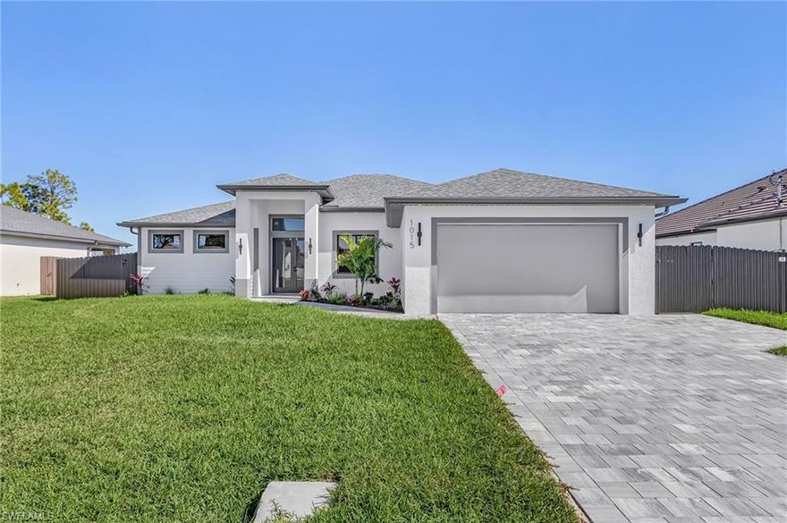 Modern Waterfront home in the heart of Cape Coral! Built with superior craftsmanship and smart design, this 4-bedroom, 3-bath residence combines elegant architecture with functionality for today’s lifestyle. Step inside to an open-concept great room, filled with natural light and adorned with custom mirrors, built-in cabinetry, and sleek finishes throughout. The gourmet kitchen features premium appliances—cooktop, refrigerator/freezer with ice maker, dishwasher, microwave, and more—perfect for entertaining or day-to-day living. The spacious primary suite offers a walk-in closet with custom storage, and a spa-inspired bath designed with accessibility in mind. Enjoy Florida living at its finest in your private saltwater pool oasis with a beautiful water display, summer kitchen, and expansive pavered patio for gatherings. The property includes a seawall for waterfront relaxation and is connected to city utilities—with ASSESSMENTS PAID! Additional highlights include a fully fenced yard, automatic sprinklers, and a two-car garage with upgraded flooring and storage. With high-end concrete block construction, handicap accessibility, and thoughtful smart home features, this home delivers everyday comfort with lasting quality. Centrally located near shopping, dining, and Cape Coral’s best waterways, 1015 SW 8th Ct effortlessly blends luxury, convenience, and the coastal charm that defines Southwest Florida living.
