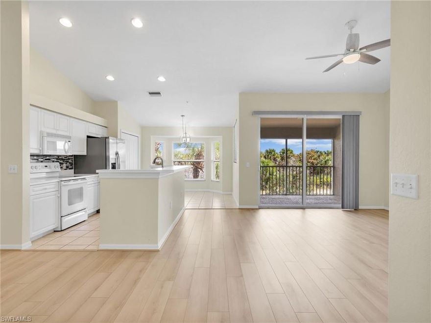 Nestled within the centrally located Bella Terra community with mature landscaping, this freshly painted second-floor condo offers 1,160 square feet of sophisticated living space designed for ultimate peace of mind. The open great room floor plan is enhanced by soaring vaulted ceilings and a neutral color palette, featuring new modern plank laminate flooring in the living areas and bedrooms with tile throughout the rest of the home-NO CARPET! The heart of the residence is the bright eat-in kitchen, which boasts a charming bay window, an open kitchen with an island, a tile backsplash, a brand new sink, and a new stainless steel refrigerator (2024). All components have been updated for peace of mind including a new roof in 2020, a new AC in 2024, and a new hot water heater in 2025. IMPACT RESISTANT DOORS AND WINDOWS THROUGHOUT, along with a hand-crank hurricane shutter for the front window provide convenient protection. The primary suite offers 2 closets, a fan, a vanity with medicine cabinet, and a walk in shower. The guest bedroom is equipped with a fan and nice sized closet with bathroom right outside. A newer Maytag washer (2020) and GE dryer can be found in the in-residence laundry closet. This residence is complete with a covered carport space with an adjacent exterior storage closet and ample guest parking, all within one of Estero’s most vibrant resort-style communities. Owners are permitted to have up to 2 pets & very flexible rentability with 30 day min and 12 leases allowed per year. Bella Terra is a gated community with 24 hour guard, nestled amidst 100 acres of lakes and 400 acres of conservation preserves. Residents enjoy the main amenity campus including 7,000 square foot clubhouse with a fitness center, resort-style pool with spa and waterfall, pickleball, tennis, bocce, and basketball courts. Other features include multi-use sports fields, an inline skate park, sand volleyball, butterfly garden, a tot-lot playground, and a social activities director on staff. Close in proximity to everything - Miromar Outlets, RSW Airport, I-75, Hertz Arena, Gulf Coast Town Center, University Village, Backyard Social Food Truck Park & more. Not in a flood zone!