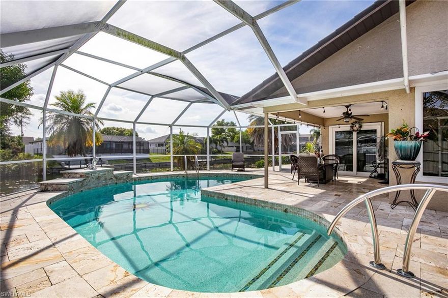 OPEN TO OFFERS- BEING SOLD AS IS. CASH ONLY. Wake up to shimmering water views in this captivating two-story waterfront pool home in the heart of Cape Coral—where comfort, style, and Florida living come together seamlessly. Designed to impress, this 4-bedroom, 3-bath residence offers an ideal layout with the primary suite on the first floor, creating both privacy and convenience.

The master retreat feels like a private spa, featuring sliders opening to the lanai, a walk-in closet, a luxurious walk-in shower, and a jetted soaking tub. The main living area invites you in with newer wood flooring, a wood-burning fireplace, and expansive views that draw your eye straight to the water. Entertain effortlessly in the formal dining room or gather around the beautifully appointed kitchen with granite countertops and stainless-steel appliances.

Step outside to your personal oasis—a large screened lanai overlooking a heated pool with a tranquil water feature, perfect for sunset swims or weekend gatherings. With city water and sewer, no HOA, in-residence laundry, and a 2-car garage, this home checks every box buyers are searching for.