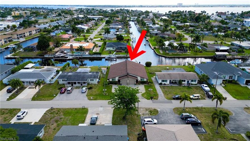 DOUBLE THE LIFESTYLE!! This RARE GULF ACCESS DUPLEX ON INTERSECTING CANALS delivers the ultimate owner-occupied or income-producing opportunity—the TRIFECTA of LOCATION, SPACIOUSNESS AND FLEXIBILITY. Opportunities like this are both RARE and UNIQUE—and nearly impossible to find. Positioned with long water views down the Venetian Canal and a VERY SHORT BOAT RIDE TO THE CALOOSAHATCHEE RIVER, this custom-built property offers something you simply don’t see—1,852 SQUARE FEET PER SIDE, allowing each unit to live larger than most single-family homes in the Yacht Club area. The layout is where this property truly stands apart. Each unit features TWO MASTER SUITES, GREATROOM concept and a highly flexible floor plan that allows for a PRIVATE EFFICIENCY WITH SEPARATE ENTRANCE or even the potential to add a THIRD BEDROOM. Whether you’re living in one side, generating income from the other, accommodating extended family, or maximizing VRBO potential, this design adapts to your needs. The kitchens remain in original—but impressive—condition. Exceptionally SPACIOUS, highly FUNCTIONAL, and LOADED WITH STORAGE, they deliver a level of space and function you simply don’t see in today’s construction. And then there’s what you rarely find in a duplex…OVERSIZED COMMERCIAL GARAGES with 9’ TALL DOORS and 27.5’ DEPTH—ideal for BOAT or TRAILER STORAGE without compromise. Outdoor living is just as compelling. Florida rooms for each unit open to pavered patios, lush landscaping and a shared JACUZZI HOT TUB WITH ELECTRIC ROOF COVER—all perfectly positioned to capture intersecting canal views and that wide-water feel you’re searching for. And there’s MORE … the major updates are already complete: 2020 DIMENSIONAL SHINGLE ROOF, 2018 IMPACT GLASS WINDOWS AND 2023 SLIDERS, 2017 HVAC, UPDATED ELECTRICAL PANELS, CPVC PLUMBING, GENERATOR and CITY WATER & SEWER. Additional features include IN-UNIT LAUNDRY, ATTIC STORAGE, WHEELCHAIR ACCESSIBILITY and a great WRAP-AROUND DOCK WITH BOAT LIFT. One unit is sold furnished (with a few exceptions), making this a seamless transition for personal use or immediate income. Located within WALKING DISTANCE to restaurants, nightlife and shopping, with an easy bike ride to the Cape Coral beach and quick access to Ft. Myers Beach, Sanibel and RSW International Airport. Properties that combine this level of LOCATION, SPACIOUSNESS AND FLEXIBILITY are RARE. Finding them on INTERSECTING GULF ACCESS CANALS is even more UNIQUE. The value here is in the flexibility—live in one side, accommodate multi-generational needs, or generate income through VACATION RENTAL, VRBO, AIRBNB, or ANNUAL RENTAL with both SHORT-TERM and LONG-TERM potential. With GULF ACCESS BOATING, INTERSECTING CANAL VIEWS, and close proximity to BEACHES, DINING, SHOPPING, and ENTERTAINMENT, this is a smart way to secure waterfront living with strong RENTAL INCOME potential and future appreciation. See it. Want it. Grab it—before someone else does! Call Today!