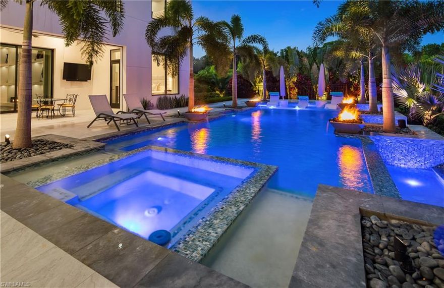 Experience privacy at its finest in this stunning custom home located in the prestigious Pine Ridge Estates. Impeccably furnished by Clive Daniel Design, this gated and fenced residence offers the utmost security and smart home technology. Step inside and be greeted by the exquisite craftsmanship and high-end finishes throughout. The gourmet kitchen and full butler's pantry are a chef's dream, while the two laundry rooms provide convenience and functionality. With 12-foot ceilings on the main level and 10-foot ceilings on the upper level,(elevator), this home boasts a spacious and airy ambiance. Indulge in the luxury of two master suites, one on each level. The main floor master suite features his and her custom-designed closets, a steam shower, a separate tub, and a smart commode. Each bedroom in this home is a suite, complete with a full bathroom, king-sized bed accommodation, and walk-in closets. Take in the breathtaking views from the two balconies on the upper level. This home is equipped with a range of desirable features, including central vacuum, Lutron shading throughout, custom drapery, and smart home technology. The property is connected to city water, with irrigation sourced from a well. Entertain with ease in the backyard oasis, featuring a salt-water pool and spa with color lighting, a screened lanai with a built-in grill and pizza oven, and more.No detail has been spared in this home, with 4 Miele dishwashers, 3 ice-makers, several beverage coolers and drawers, and a large wine room. The extensive landscaping and lighting create a picturesque setting, and the property even includes a generator for peace of mind.Situated on over an acre lot, there is ample space to accommodate a guest house, with plans already prepared. Don't miss the opportunity to own this exceptional property that offers both luxury and privacy. North and South garage can each hold 4 cars with a lift system. X-500 Flood zone.