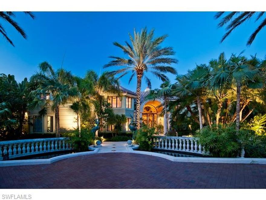 Ideally situated on one-and-one-half lots on the prestigious, tree-lined Galleon Drive, this grand estate offers more than 165 feet of water frontage and seemingly endless bay views. Enter the grand foyer through the stunning wrought iron doors and see floor-to-ceiling windows that give way to seamless water views over the mosaic, fiber optic lit, negative-edge pool and spa as well as Naples Bay. Interior features are virtually endless, including but not limited to an expertly appointed kitchen complete with wine grotto and butler's pantry, breakfast room encompassed by radial glass, custom millwork and detailed finishes throughout. The outdoor living space features expansive and beautifully landscaped stone decking with matching coquina shelled balustrades, superbly designed outdoor kitchen and bar and multiple stocked koi ponds. Port Royal Club membership eligibility.