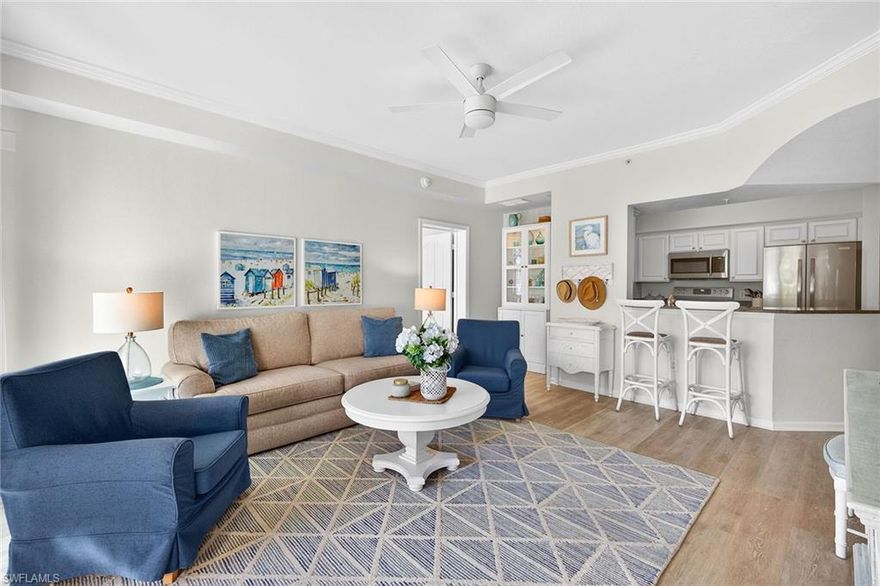 This light-filled 2-bedroom, 2-bathroom Tuscany model offers 1,067 sq ft of thoughtfully designed living space, featuring a split bedroom floor plan that ensures ample space and privacy. The kitchen boasts stainless steel appliances and granite countertops for creating delightful meals. Light hardwood flooring throughout highlights the coastal casual vibe of this warm and inviting first floor home. A gated community known for its lush landscaping and exceptional amenities, Positano residents enjoy access to a resort-style pool and spa, elegant clubhouse, fitness center, business center, game room, and a beautiful entertainment kitchen.  On-site management keeps everything running smoothly and looking pristine.  Whether you prefer an active lifestyle or just enjoying quality time with family and friends, this community has it all. Designed around two charming lakes and a natural preserve, the convenient Naples locale gives easy access to beautiful beaches, shopping, dining, and all kinds of entertainment. As a full-time residence or seasonal escape, this unit checks all the boxes. *Pet-friendly too!*